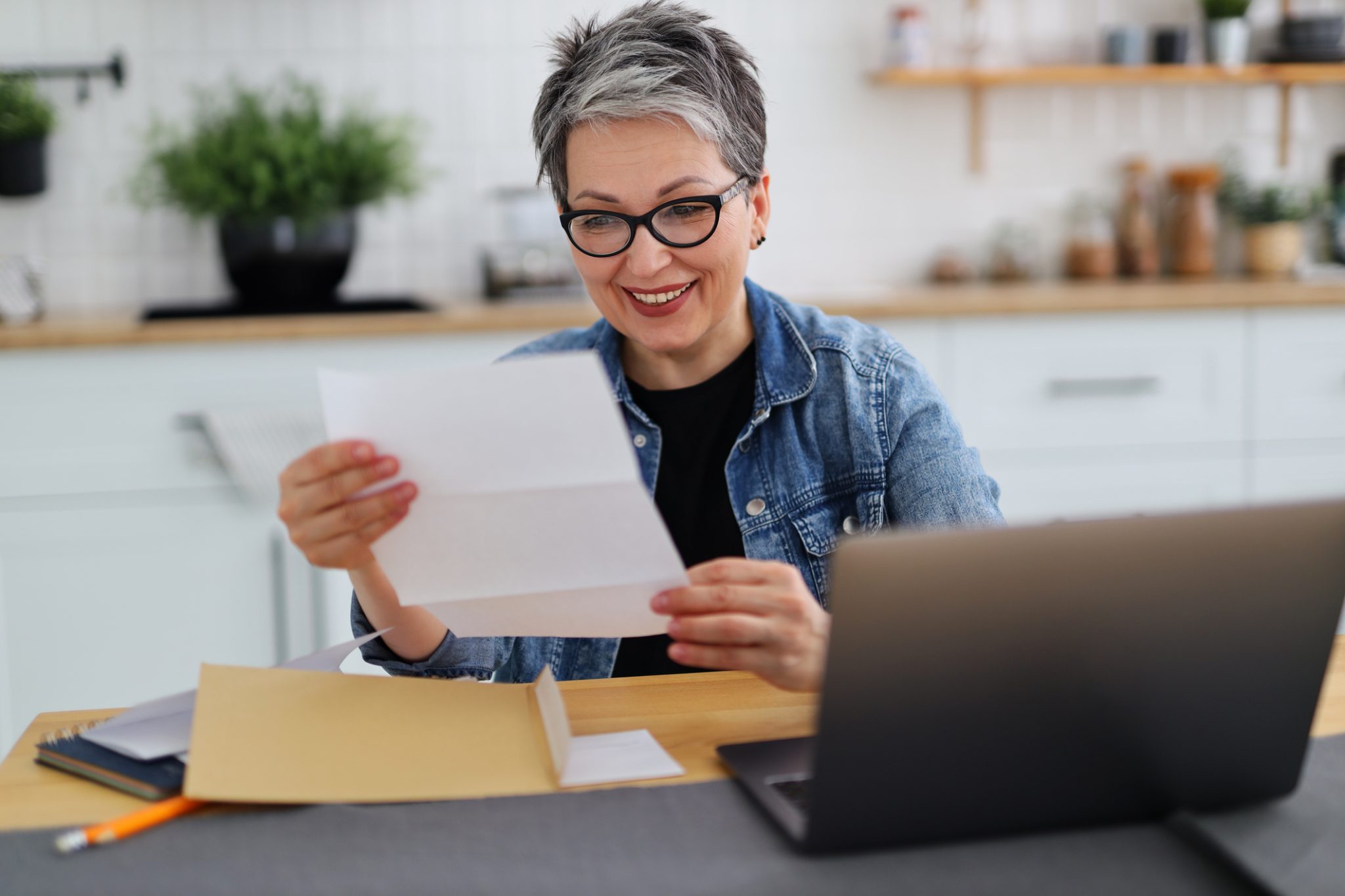 A woman holding her receipt and smiling after receiving money back through the Inflation Reduction Act rebate program.