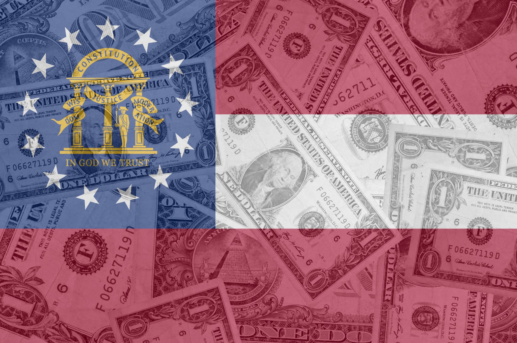 The Georgia state flag with dollar bills blurred in the background, indicating the release of IRA funds in the state.