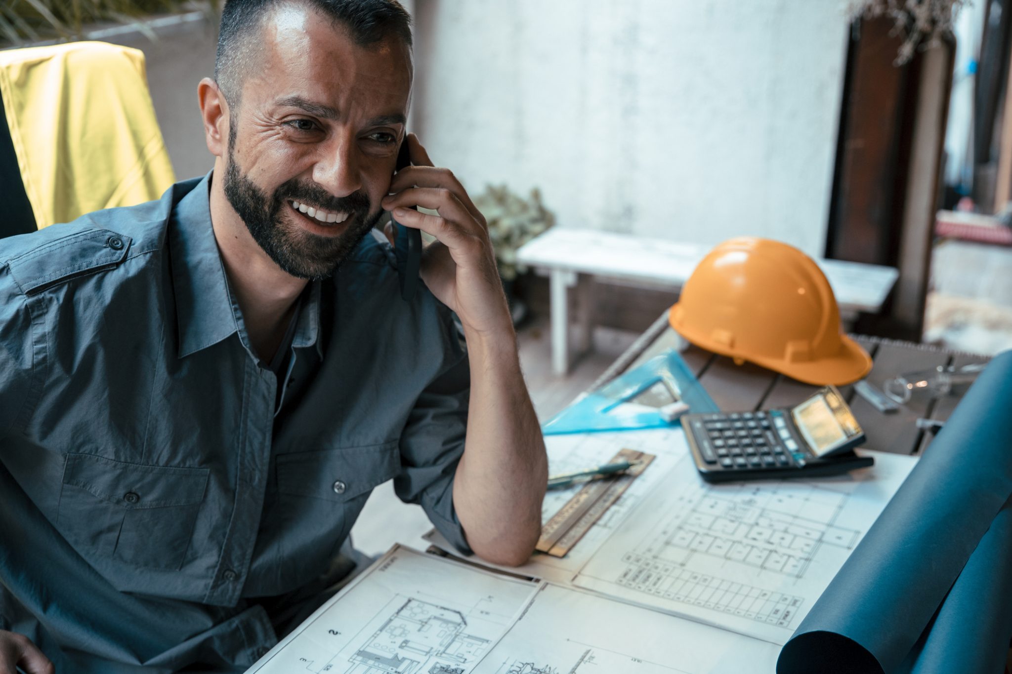 An IRA rebate contractor speaking on the phone to the experts at MyNewHeatPump while filing paperwork.